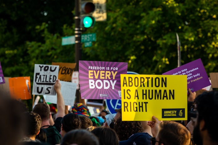 Image of protestors with placards demanding reproductive justice